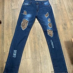 Distressed cheetah print stretch jeans